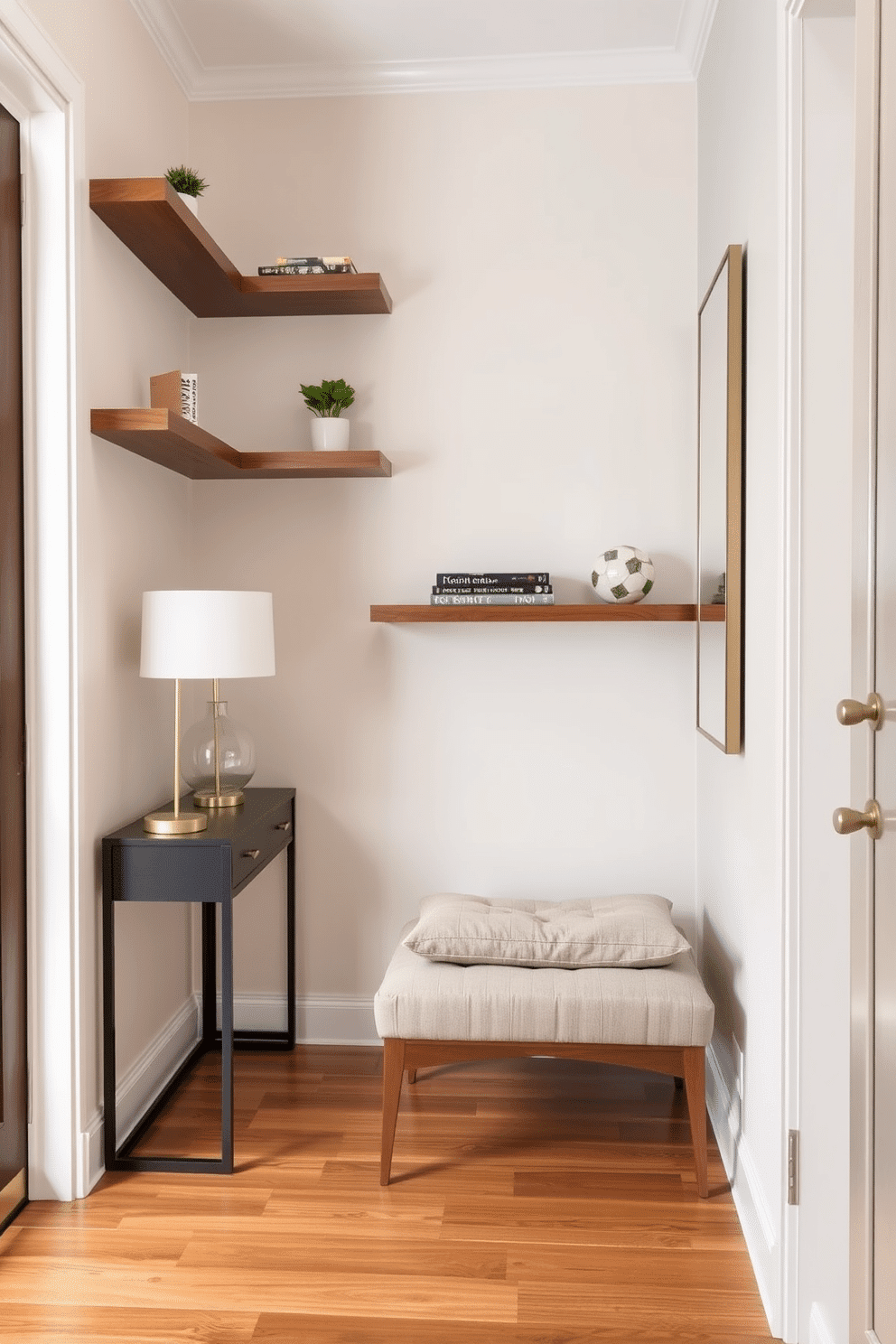 A narrow foyer designed with elegance features floating shelves on the walls, adorned with decorative accents like small plants and stylish books. The floor is finished with polished wood, and a sleek console table sits against one wall, topped with a contemporary lamp and a chic mirror above it. The walls are painted in a soft, inviting color, creating a warm atmosphere as you enter. A small bench with plush cushions is placed below the shelves, providing a cozy spot for putting on shoes.