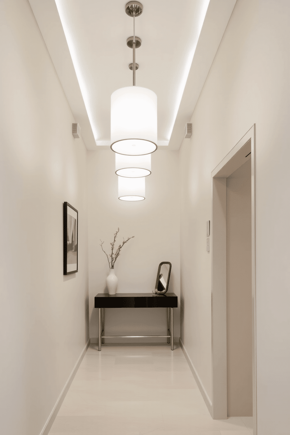 A sleek, modern foyer features a narrow layout accentuated by minimalist lighting fixtures that hang elegantly from the ceiling. The walls are adorned with a soft, neutral paint, while a narrow console table with a glossy finish sits against one side, topped with a contemporary vase and a small decorative mirror.