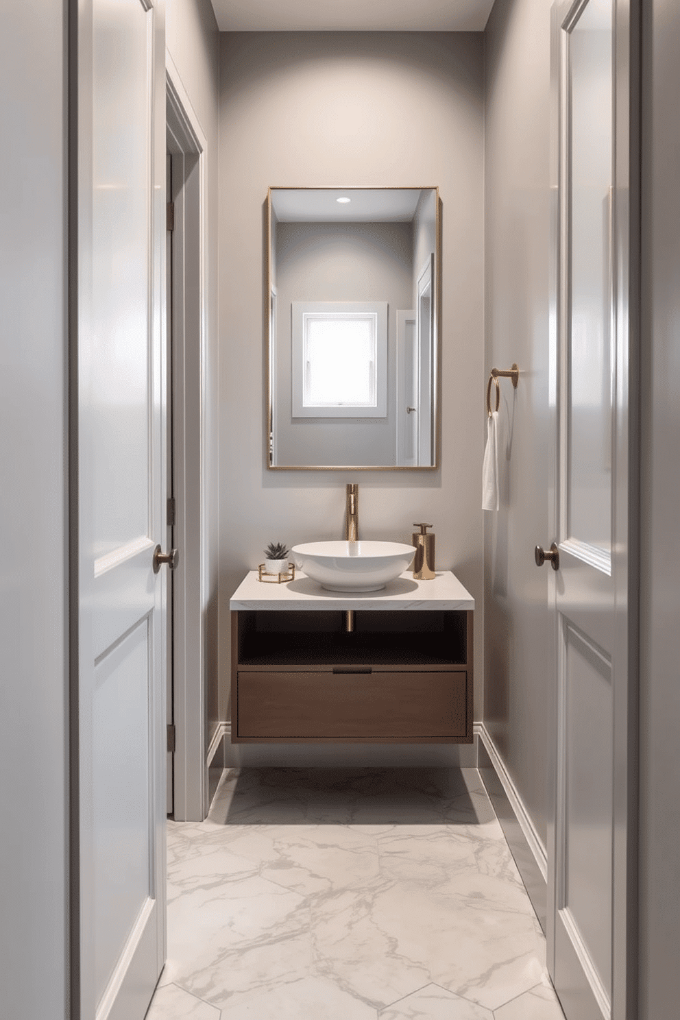 A narrow powder room featuring a sleek pocket door that maximizes space efficiency. The walls are painted in a soft, light gray, complemented by a stylish floating vanity with a vessel sink and brushed gold fixtures. The floor is adorned with elegant hexagonal tiles in a subtle marble pattern, creating a sense of luxury. A large, frameless mirror hangs above the vanity, reflecting the natural light that filters in through a small window.