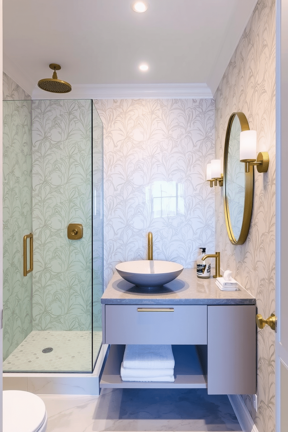 A stylish powder room featuring a sleek glass shower enclosure that creates an open and airy feel. The walls are adorned with elegant wallpaper in soft pastels, complemented by a chic floating vanity with a vessel sink and brushed gold fixtures.