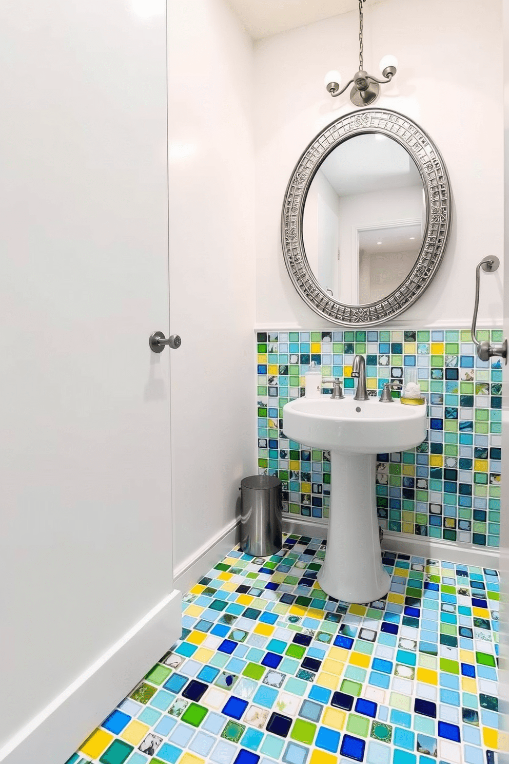 A vibrant powder room featuring an eye-catching floor design made of brightly colored glass tiles in various shades of blue, green, and yellow. The tiles create a playful mosaic pattern that energizes the space and complements the sleek, modern fixtures. The walls are painted in a soft white to enhance the brightness of the tiles, while a stylish pedestal sink adds elegance. A round mirror with a decorative frame hangs above the sink, reflecting the colorful tiles and creating a sense of depth in the room.