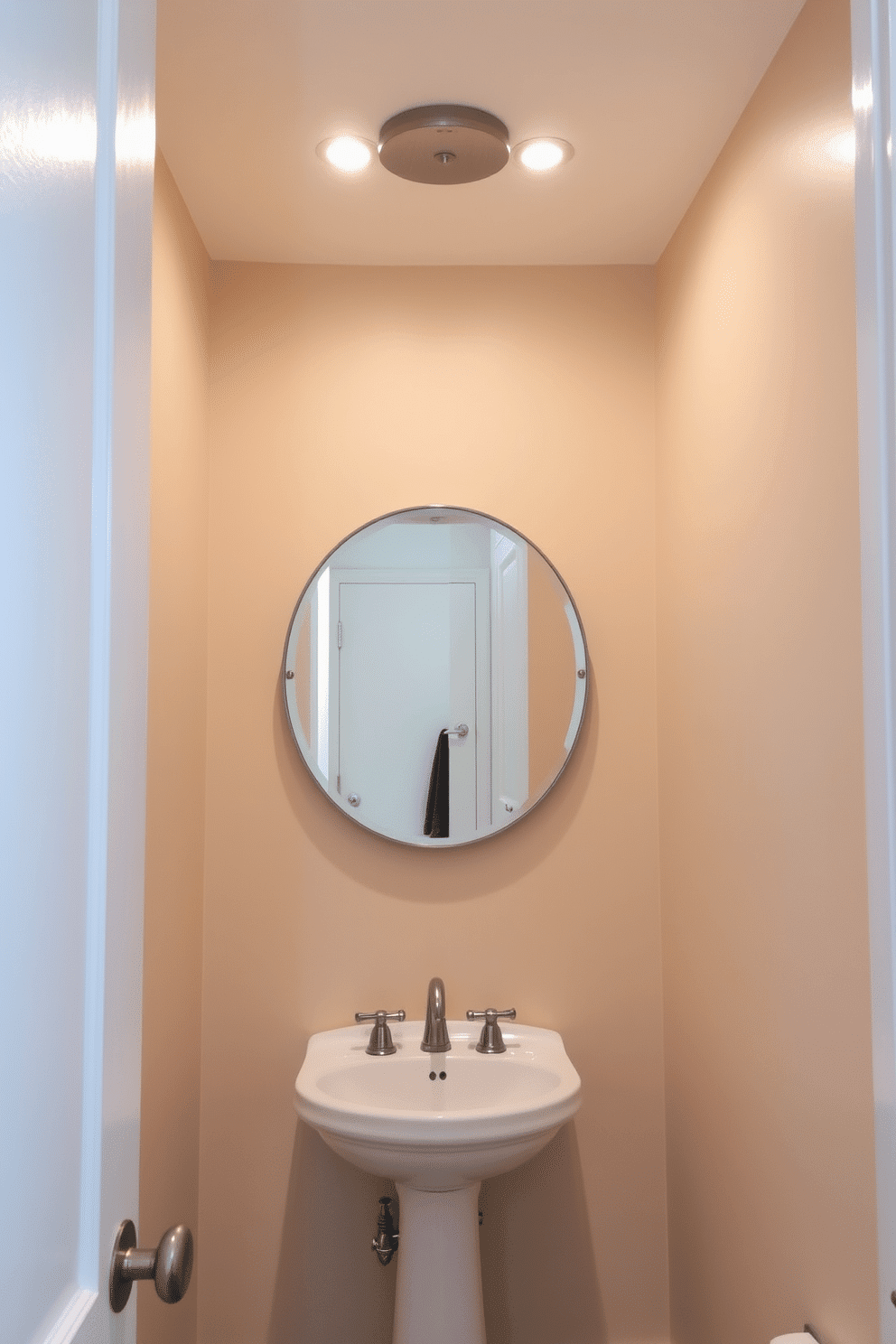 A stylish powder room featuring flush mount lights that enhance the space without overwhelming the low ceiling. The fixtures are sleek and modern, finished in brushed nickel, providing a warm glow that complements the soft beige walls. The room includes a petite pedestal sink with a vintage-inspired faucet, creating a charming focal point. A round mirror with a decorative frame reflects the light, making the space feel larger and more inviting.