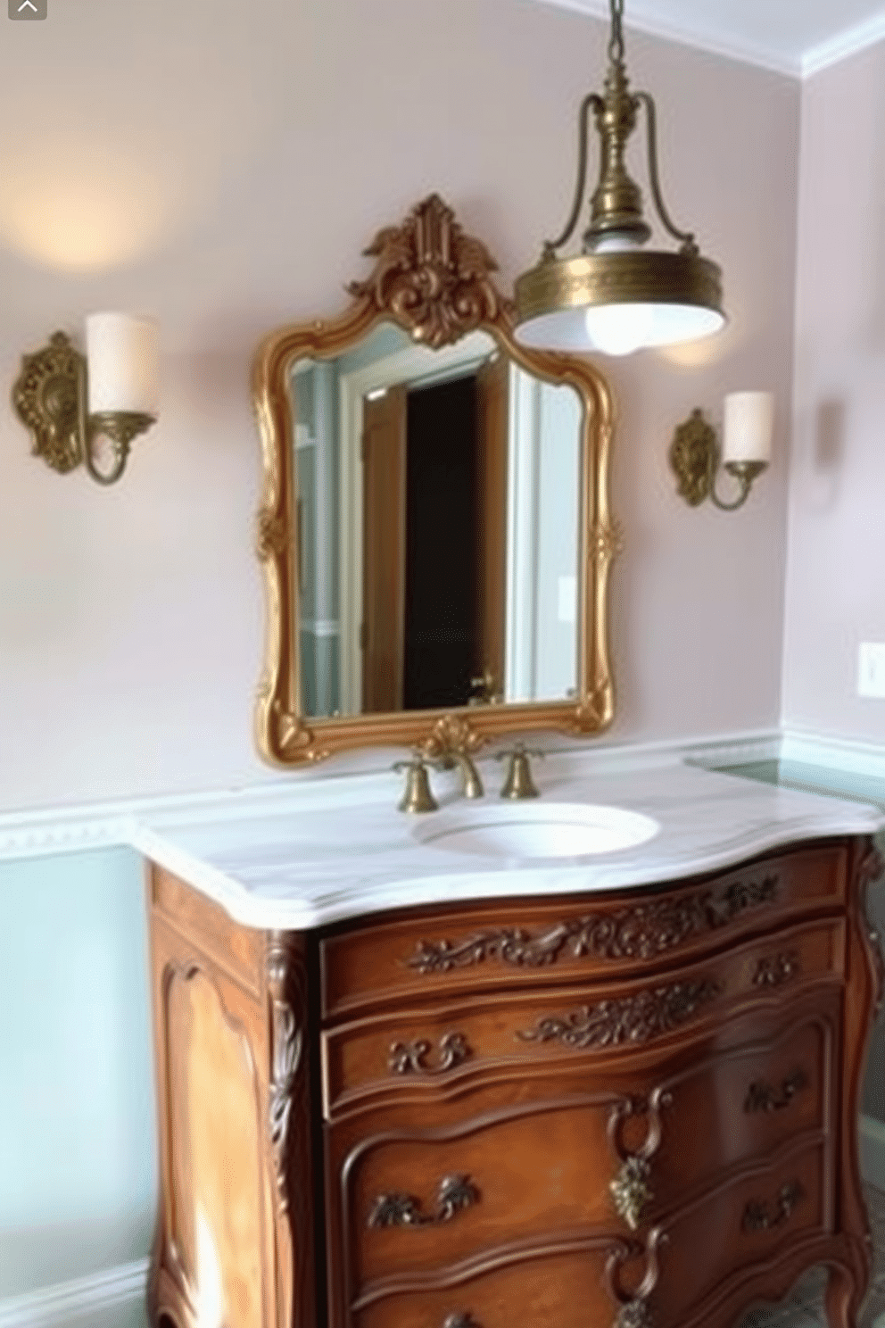 A vintage dresser has been elegantly repurposed as a vanity, showcasing its intricate carvings and rich wood finish. The top is adorned with a polished marble surface, reflecting the soft glow of a vintage-style pendant light overhead. On either side of the dresser, stylish wall sconces provide warm illumination, enhancing the room's charm. The powder room features a soothing palette of pastel colors, complemented by a decorative mirror framed in distressed gold.