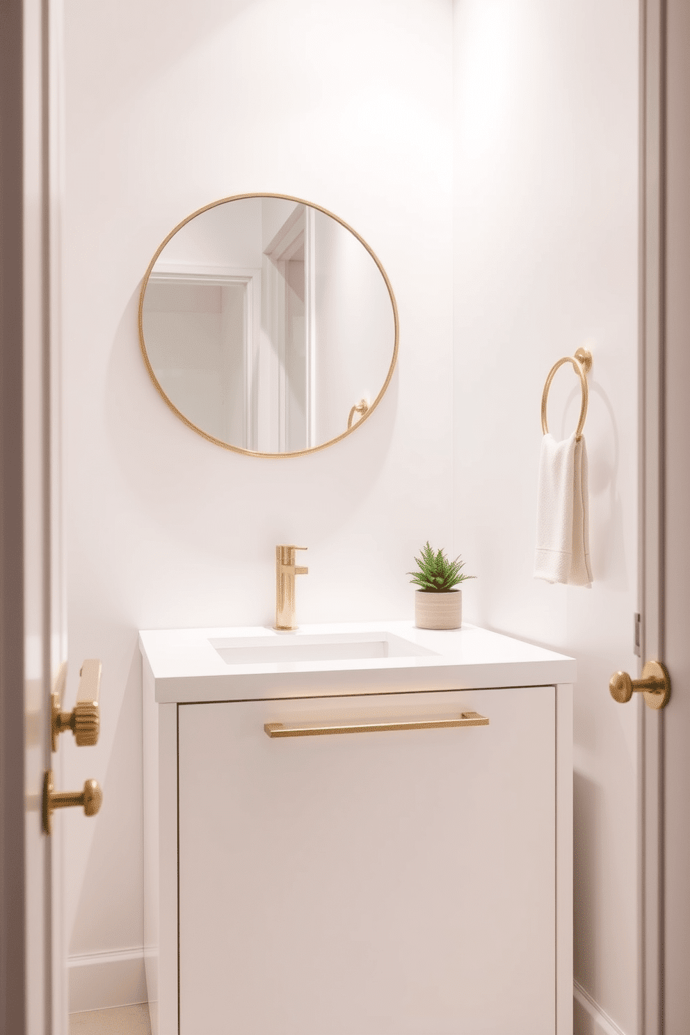 A minimalist white vanity with sleek gold accents creates a chic focal point in the powder room. The clean lines of the vanity are complemented by a round mirror with a thin gold frame, enhancing the elegant simplicity of the space. The walls are adorned with a soft, neutral hue, providing a serene backdrop that highlights the vanity's design. A small potted plant sits on the countertop, adding a touch of greenery and warmth to the modern aesthetic.