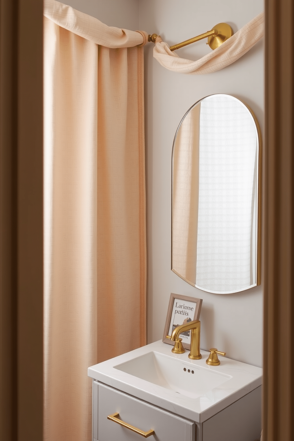 Elegant fabric wall hangings drape gracefully across the walls of a chic powder room, adding depth and warmth to the space. The fabric features intricate patterns in soft hues, creating a serene backdrop for stylish decor elements. Incorporating a blend of textures, the wall hangings complement a sleek modern vanity with a polished gold faucet. A small, framed art piece in muted colors is positioned above the vanity, enhancing the overall elegance of the room.