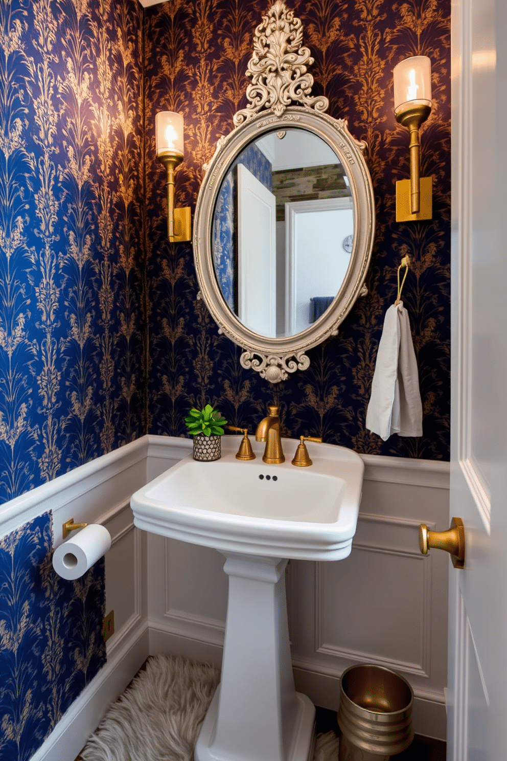 A stylish powder room showcasing layered textures for visual interest. The walls are adorned with a bold, patterned wallpaper featuring deep blues and gold accents, complemented by a sleek white pedestal sink and a vintage-inspired mirror with intricate detailing. The space is enhanced with a plush area rug that adds warmth, while brushed gold fixtures and accessories provide a touch of elegance. A small potted plant sits on the sink, bringing a refreshing pop of greenery to the design.