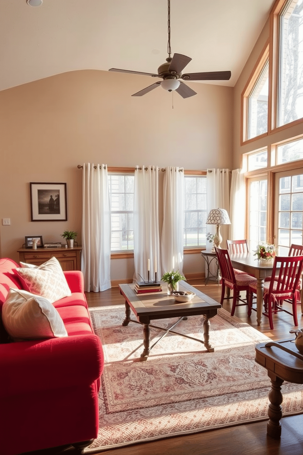 A warm family room designed for comfort and style. The focal point is a plush red upholstered sofa, complemented by matching red dining chairs that create a cohesive look around a rustic wooden dining table. Large windows allow natural light to flood the space, while sheer white curtains soften the ambiance. A cozy area rug in neutral tones anchors the seating area, and decorative pillows add a pop of color and texture.