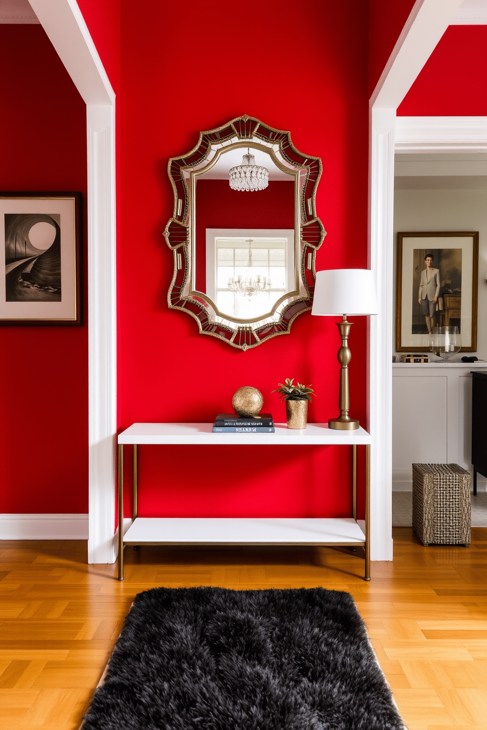 A striking red foyer welcomes guests with a bold statement console table at its center. The walls are adorned with elegant artwork, and a chic mirror with a decorative frame reflects the vibrant color. The console table features a sleek design, topped with decorative items like a stylish lamp and a small potted plant. A plush runner in contrasting colors adds warmth to the polished hardwood floor, enhancing the overall inviting atmosphere.