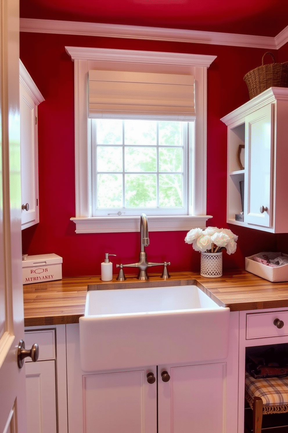 A vibrant red laundry room features a large farmhouse sink with a brushed nickel faucet, surrounded by white cabinetry for ample storage. The walls are painted a rich crimson, complemented by a rustic wooden countertop that adds warmth to the space.