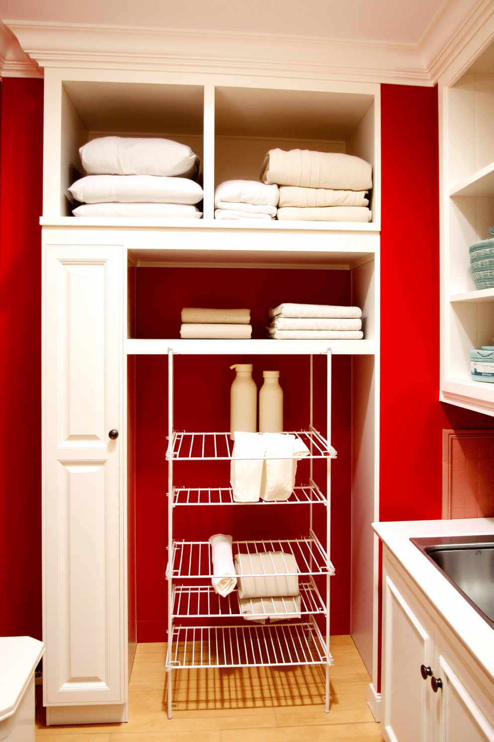 A vibrant red laundry room features a built-in drying rack seamlessly integrated into the cabinetry, providing both functionality and style. The walls are painted a bold crimson, complemented by white shelving that holds neatly folded linens and laundry supplies.