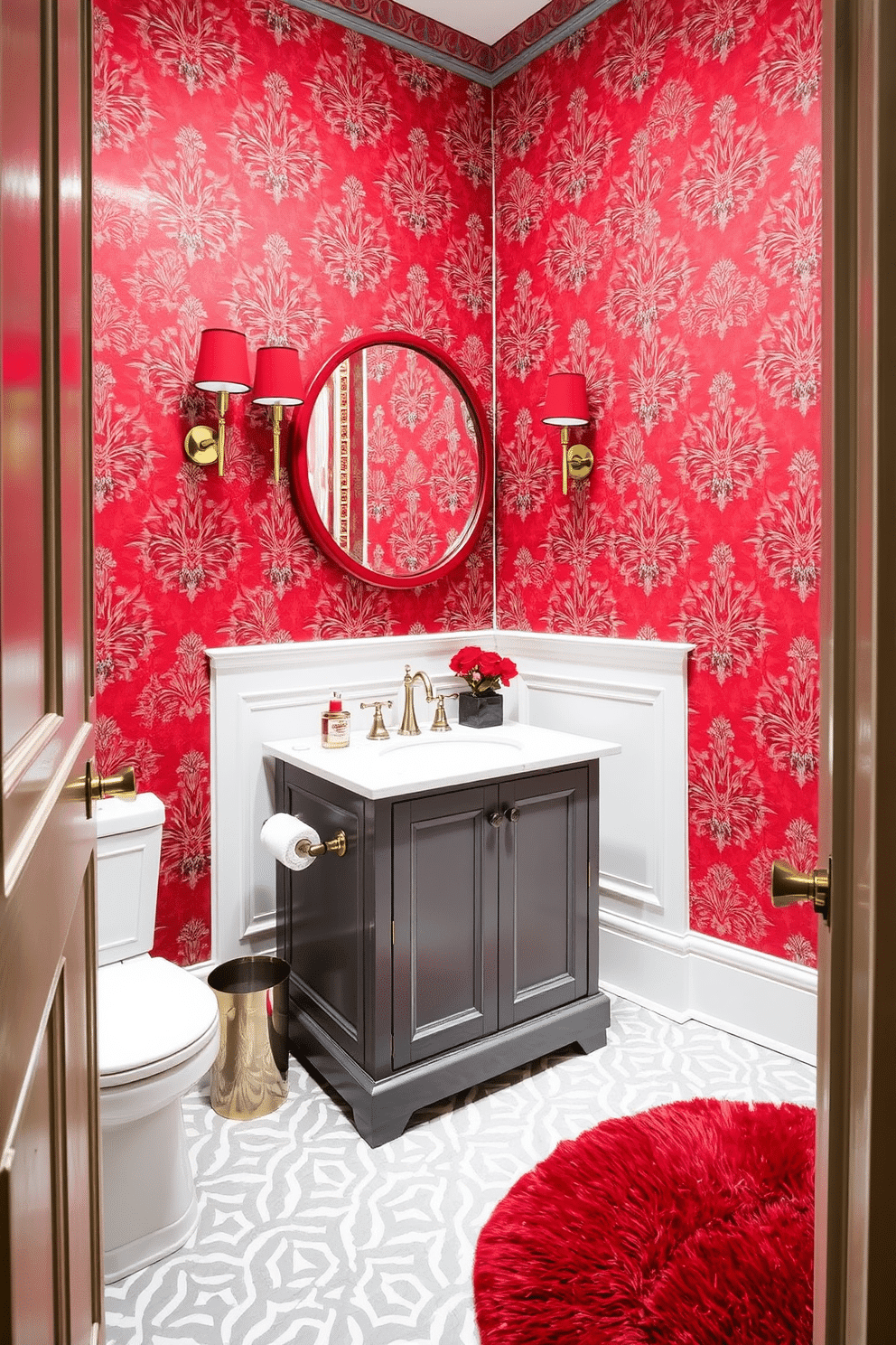 A classic red and gray powder room features a striking red wallpaper adorned with intricate gray patterns. The vanity is a sleek gray with a white marble top, complemented by a round mirror with a red frame above it. On the floor, a gray and white geometric tile adds a modern touch, while a plush red rug provides warmth. Elegant sconces with red shades flank the mirror, casting a soft glow throughout the space.