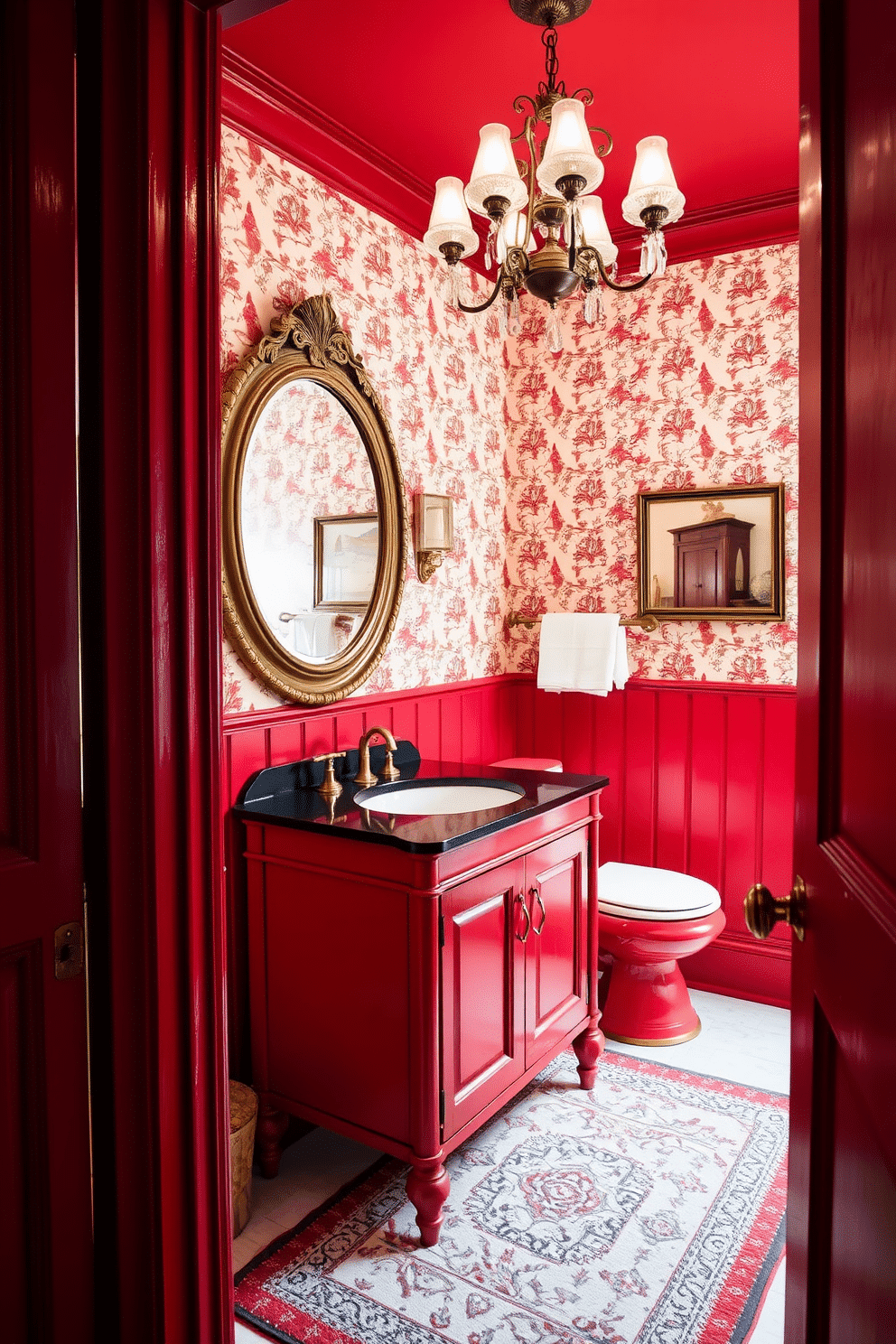 A vintage red powder room featuring classic red furniture that exudes a retro vibe. The walls are adorned with playful wallpaper, and a stylish chandelier hangs from the ceiling, adding a touch of elegance. The room includes a striking red vanity with a sleek black countertop and a round mirror framed in antique gold. Accents of brass fixtures and a patterned area rug complete the nostalgic atmosphere, creating a charming and inviting space.