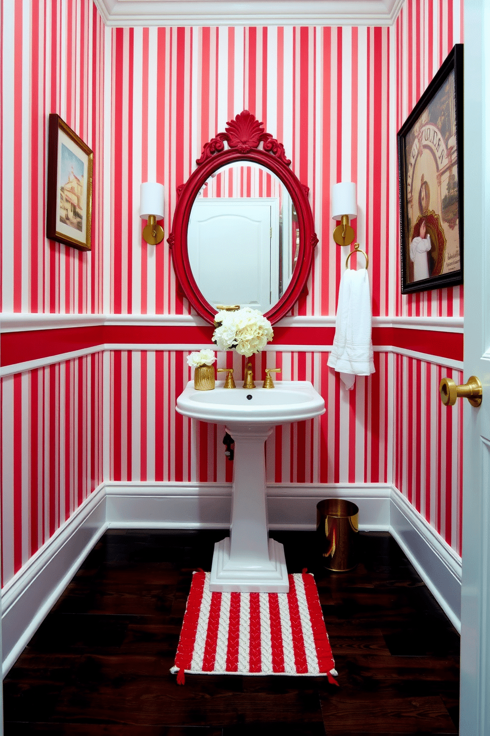 A chic powder room featuring elegant red and white striped wallpaper that adds a touch of sophistication. The space includes a sleek white pedestal sink complemented by a vintage-style gold faucet and a round mirror with a decorative red frame. The floor is adorned with dark hardwood, providing a rich contrast to the bright walls. A small, stylish red and white striped rug sits beneath the sink, while a bouquet of fresh white flowers in a gold vase adds a pop of color to the countertop.