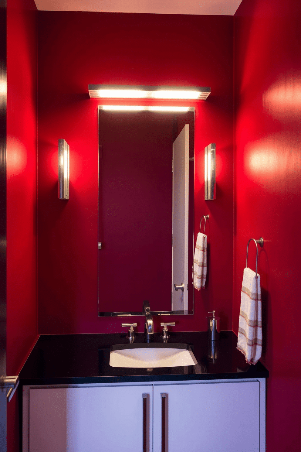 A modern red powder room featuring sleek, contemporary lighting fixtures that cast a warm, inviting glow. The walls are adorned with a deep crimson hue, complemented by a minimalist white vanity and a striking black countertop.