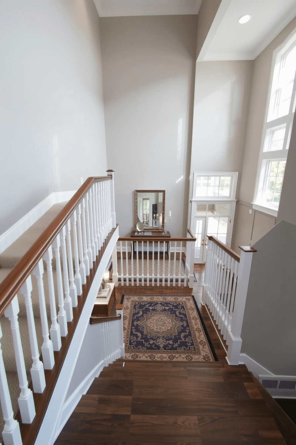 An elegant L-shaped staircase features a sleek wooden handrail and white balusters, leading to a spacious landing area adorned with a stylish area rug. The walls are painted in a soft gray, complemented by recessed lighting that highlights the architectural details of the staircase. The landing area is furnished with a small console table and a decorative mirror, creating a welcoming transition to the second floor. Large windows allow natural light to flood the space, enhancing the airy ambiance and showcasing the beautiful craftsmanship of the staircase.