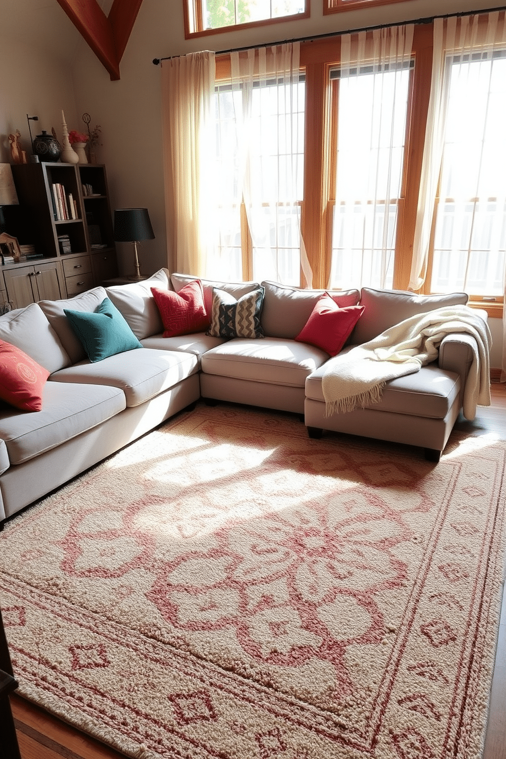 A cozy family room featuring layered rugs that add texture and warmth to the space. The room includes a plush sectional sofa in a neutral tone, complemented by colorful throw pillows and a soft, inviting blanket draped over the armrest. A large area rug anchors the seating area, while a smaller, patterned rug lies on top, creating visual interest. Natural light pours in through large windows adorned with sheer curtains, illuminating the room's warm wood accents and inviting atmosphere.