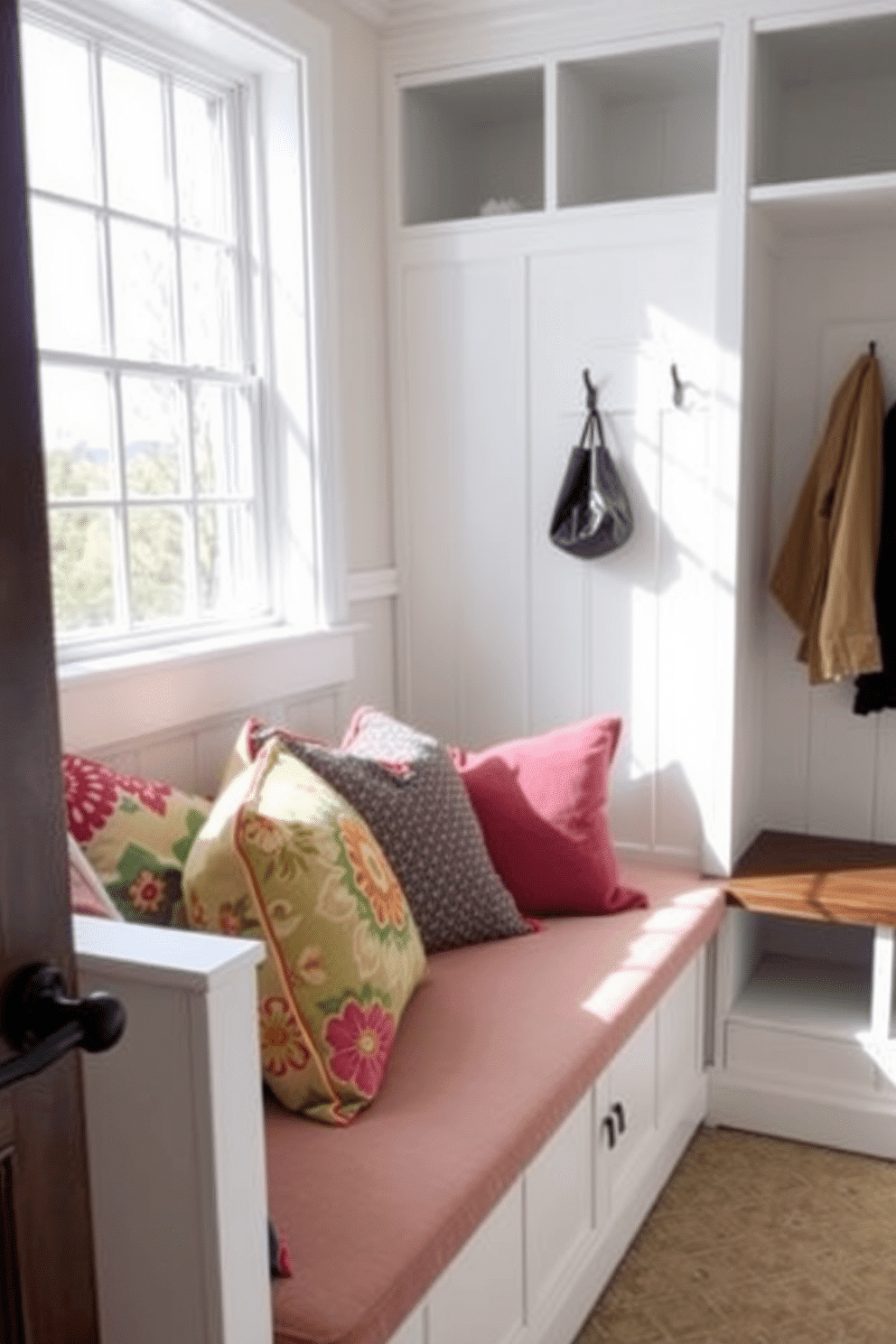 Cozy bench with colorful cushions. The bench is upholstered in a soft fabric with a mix of vibrant patterns, surrounded by natural light from a nearby window. Simple mudroom design ideas. The space features a practical layout with built-in shelves for storage, a durable bench for seating, and hooks for hanging coats, all in a neutral color palette to create a welcoming atmosphere.