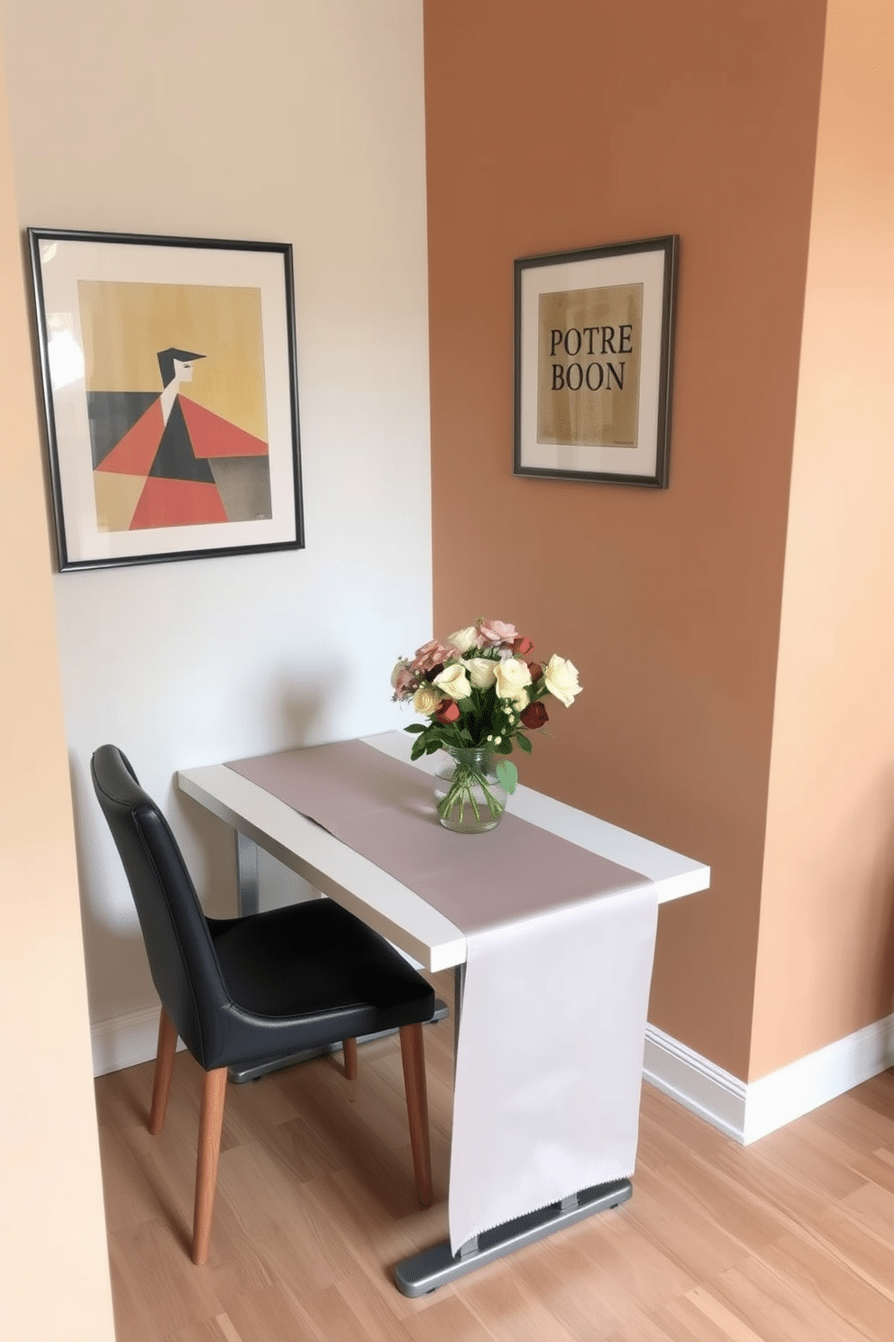 A narrow dining table is positioned against the wall, adorned with a sleek table runner and a centerpiece of fresh flowers. The walls are painted in a soft, warm tone, complemented by stylish artwork that adds character to the small dining room.