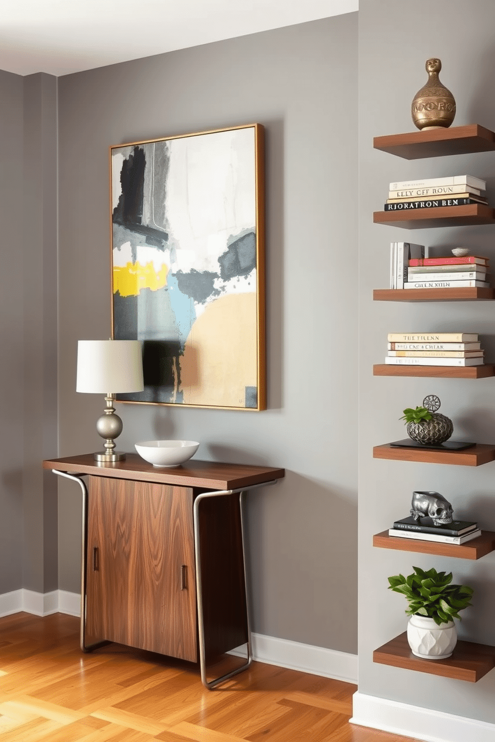 A small foyer features a sleek console table with a rich walnut finish, topped with a stylish lamp and a decorative bowl. The walls are painted in a soft gray, adorned with a large abstract painting that adds a pop of color and personality to the space. Floating shelves line one wall, showcasing an array of curated decorative items, including books, plants, and unique sculptures. The flooring is a warm hardwood, complementing the overall design and creating an inviting atmosphere for guests.