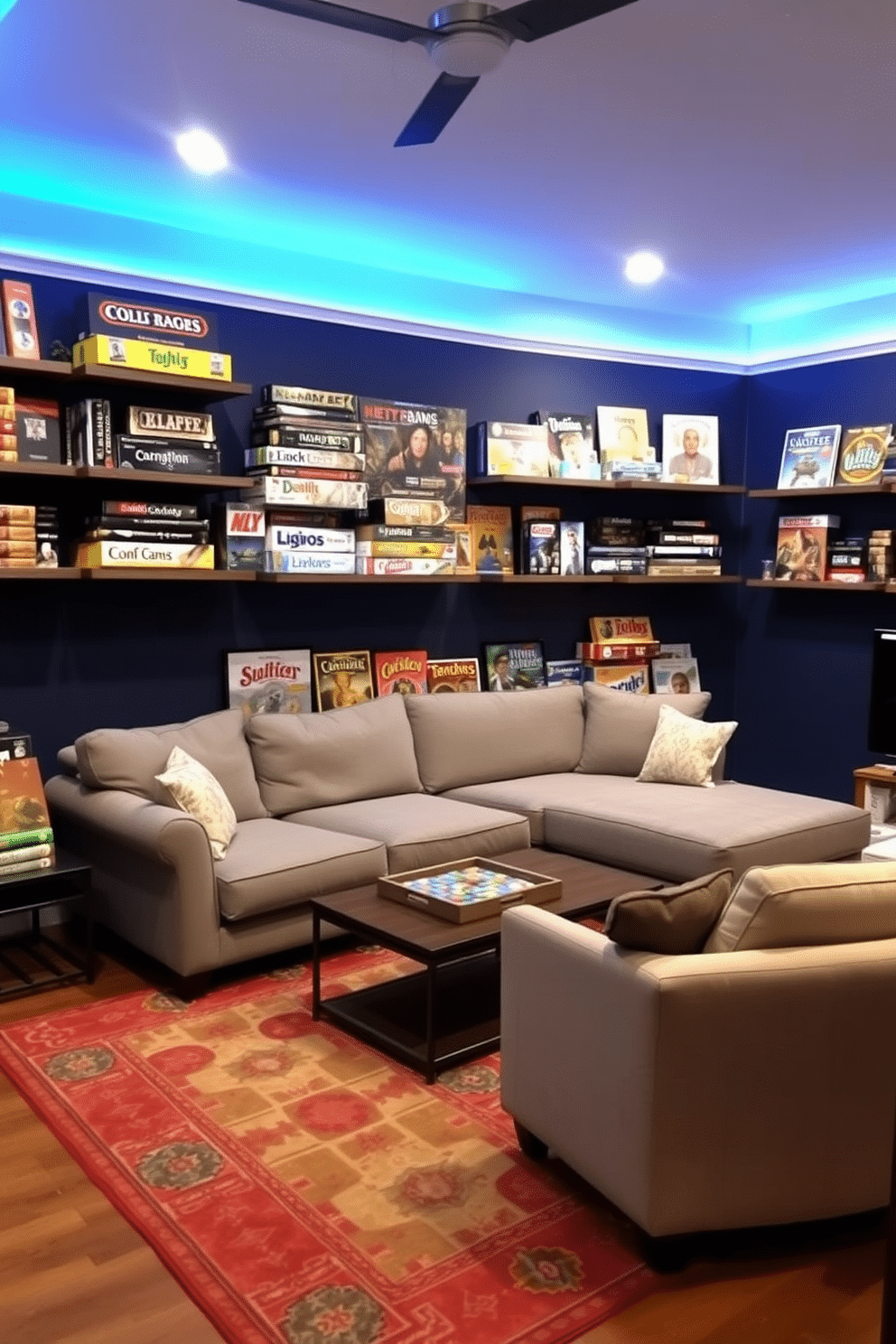 A cozy game room features wall-mounted shelves filled with an array of board games, creating an inviting and playful atmosphere. The walls are painted in a deep navy blue, complemented by soft, ambient lighting that enhances the room's warm, welcoming vibe. A plush sectional sofa in a light gray fabric faces a stylish coffee table, perfect for game nights. The floor is covered with a vibrant area rug, adding a pop of color and comfort to the space.