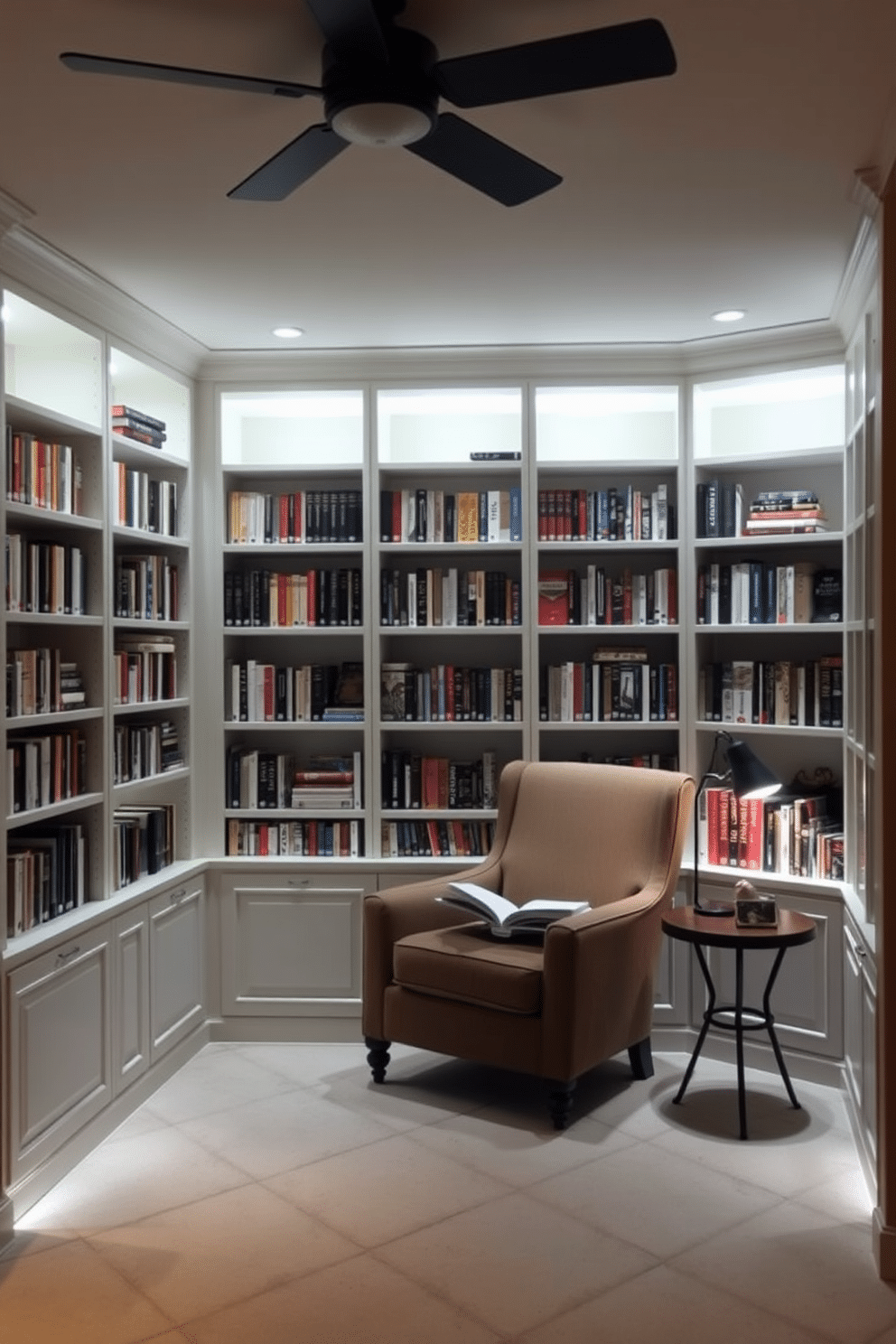 A cozy small home library features built-in shelves lined with books, illuminated by soft hidden lighting that casts a warm glow. A comfortable reading nook with a plush armchair and a small side table is nestled in one corner, creating an inviting space for relaxation.