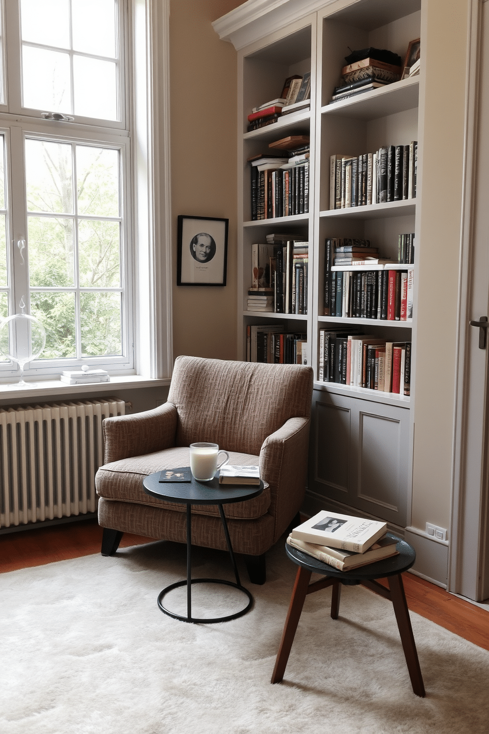 A cozy nook features a plush armchair upholstered in soft, textured fabric, positioned near a large window that allows natural light to flood the space. A small side table holds a stack of books and a steaming cup of tea, creating an inviting reading atmosphere. The walls are lined with built-in shelves filled with an eclectic mix of books and decorative items, adding character to the small home library. A warm, neutral color palette enhances the tranquility of the space, while a soft area rug anchors the seating area, inviting relaxation.