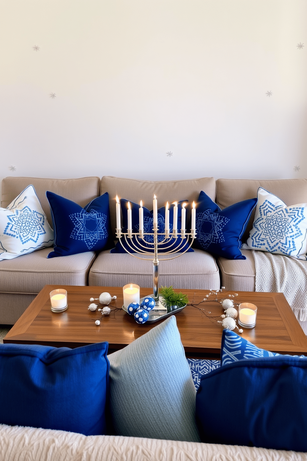 A cozy living room adorned for Hanukkah, featuring festive blue and white throw pillows scattered across a plush sofa. The walls are decorated with subtle silver accents, and a menorah sits elegantly on the coffee table, surrounded by delicate candles and seasonal decorations.