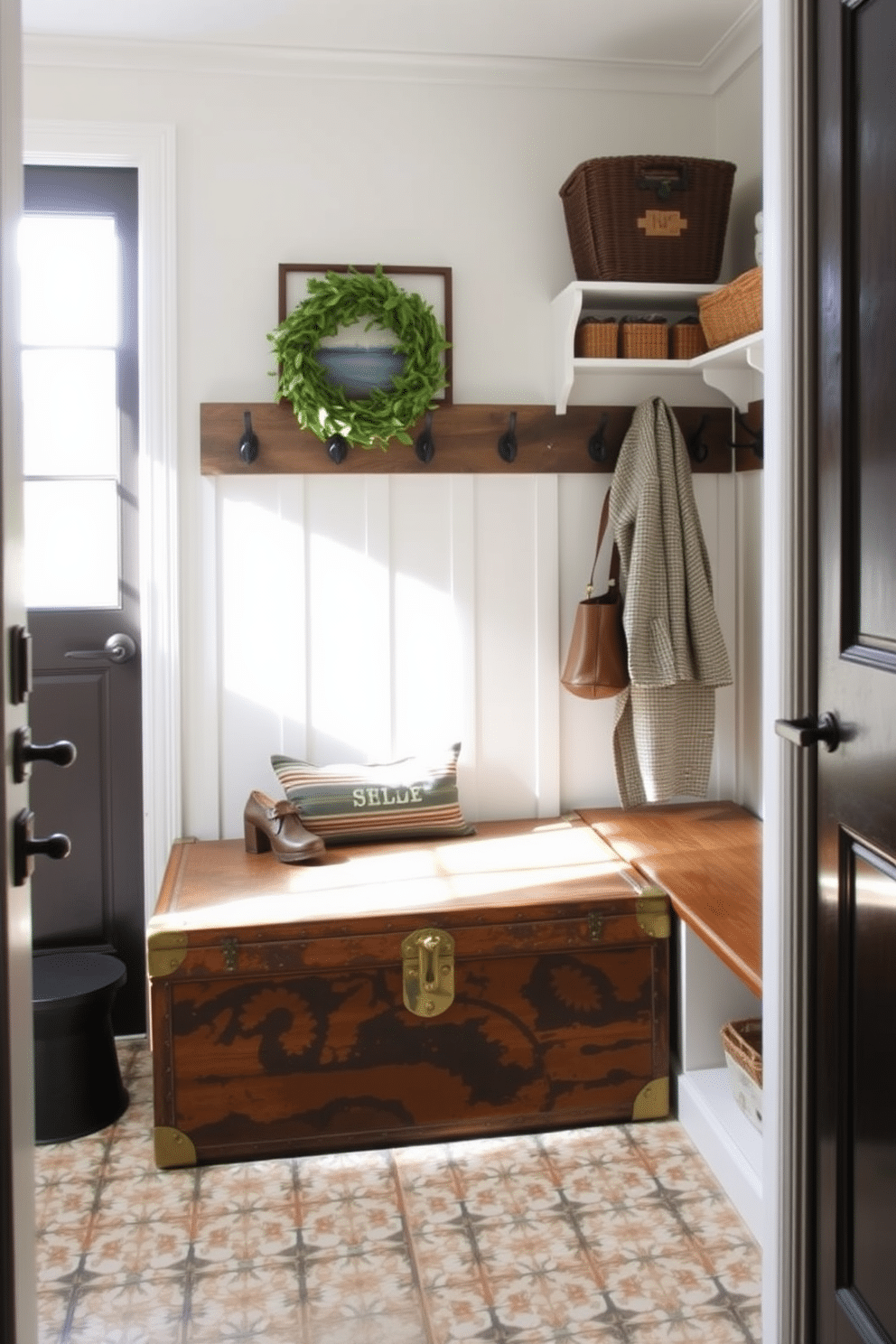 A vintage trunk serves as a unique storage solution, adding character and charm to any space. Its weathered wood and brass accents provide a perfect contrast to modern decor elements while offering ample room for shoes and outdoor gear. The small mudroom features a functional layout with built-in benches and hooks for coats. Soft, muted colors and natural light create an inviting atmosphere, while patterned tiles add a touch of style to the entryway.