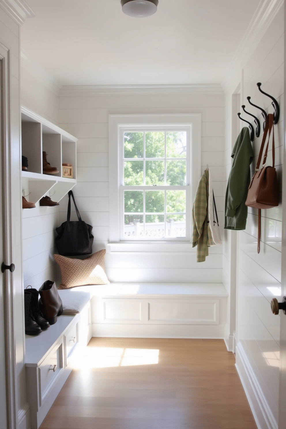 A small mudroom designed with bright, natural lighting to create a welcoming atmosphere. The space features a built-in bench with soft cushions, surrounded by white shiplap walls and a cheerful color palette. On one side, there are open shelves for shoes and bags, complemented by stylish hooks for coats and accessories. A large window allows sunlight to flood the room, enhancing the inviting ambiance.