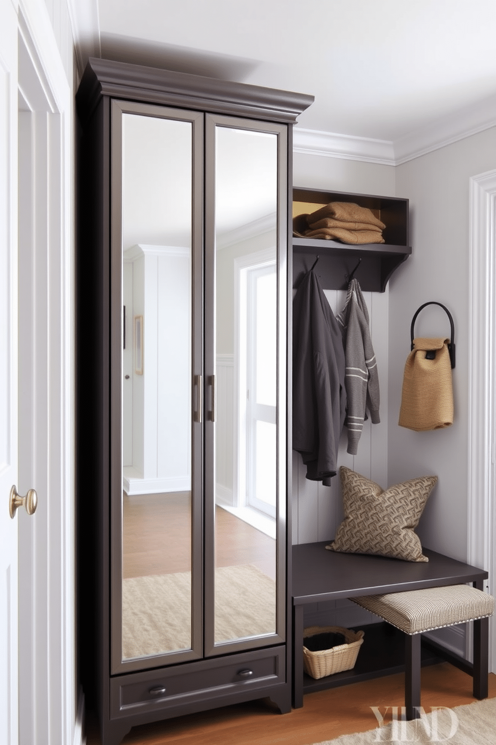 A stylish mudroom featuring a mirrored cabinet that enhances functionality while adding a touch of elegance. The space is designed with practical storage solutions, including hooks for coats and a bench for seating, complemented by a light color palette that creates a welcoming atmosphere.