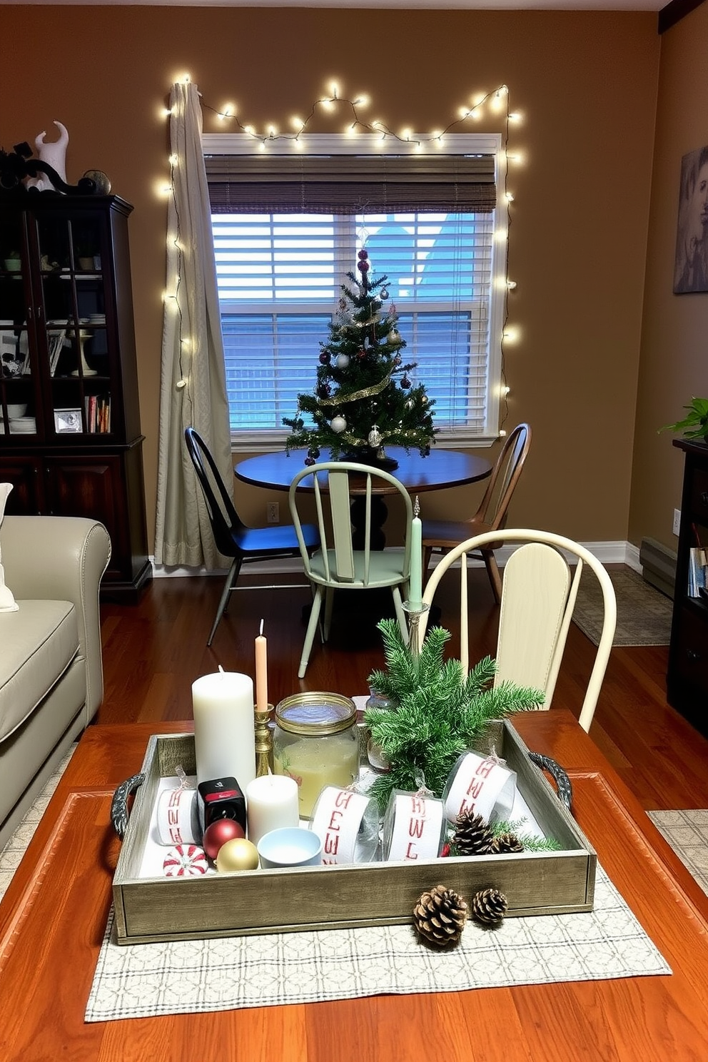 A cozy living room adorned for the holidays, featuring a decorative tray on the coffee table filled with festive items like candles, ornaments, and seasonal greenery. The walls are painted in warm tones, and a small, elegantly decorated Christmas tree stands in the corner, adding a touch of cheer without overwhelming the space. A compact dining area set for a holiday meal, showcasing a decorative tray at the center of the table that holds a collection of holiday-themed napkin rings and a small arrangement of pinecones. Surrounding the table, mismatched chairs add character, while twinkling fairy lights drape across the window, creating a warm and inviting atmosphere.