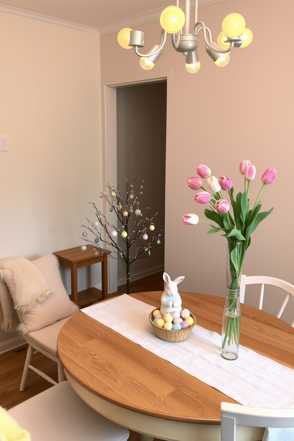 A cozy living room decorated for Easter. A small Easter tree stands on a wooden side table, adorned with pastel-colored ornaments and tiny lights, casting a warm glow. The walls are painted a soft beige, and a plush, cream-colored sofa sits against one wall, complemented by a fluffy, pastel yellow throw blanket. On the coffee table, a ceramic bunny figure sits next to a basket filled with colorful Easter eggs, adding a festive touch to the space. A compact dining area with an Easter theme. A small Easter tree with delicate, hand-painted ornaments serves as the centerpiece on the round wooden dining table, surrounded by white chairs with pastel-colored cushions. The walls are a light gray, and a simple, white linen tablecloth drapes over the table, enhancing the room's airy feel. Above the table, a chandelier with soft yellow bulbs illuminates the space, while a vase of fresh tulips in soft pinks and whites adds a touch of springtime elegance.