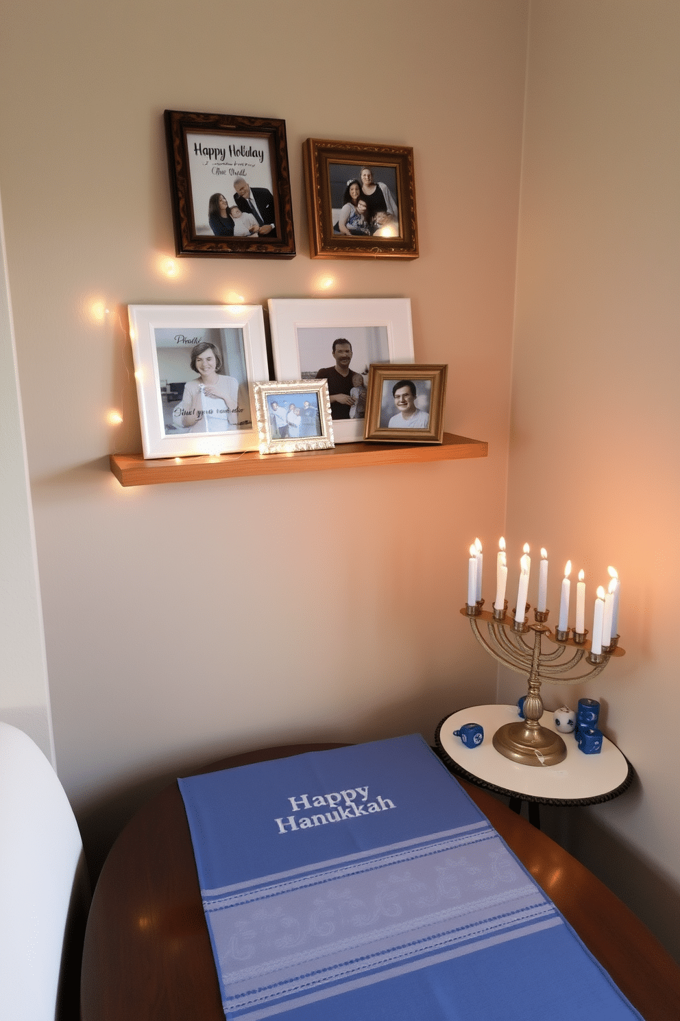 A cozy corner features a small wooden shelf adorned with framed family photos, each in festive holiday frames that celebrate cherished memories. The shelf is complemented by a delicate string of fairy lights that add a warm glow to the space. In the same area, a compact menorah sits on a nearby table, surrounded by small decorative items like dreidels and blue-and-white candles. A festive table runner in shades of blue and silver adds a touch of elegance, creating a welcoming atmosphere for Hanukkah celebrations.