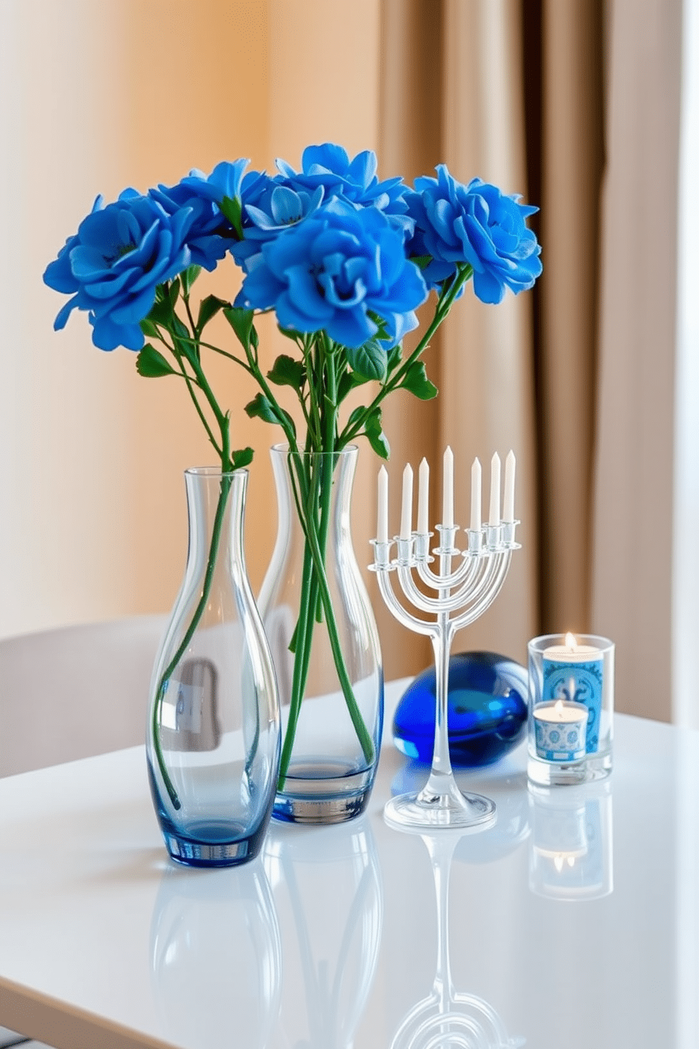 Elegant glass vases filled with vibrant blue flowers are artfully arranged on a sleek, minimalist table. The vases, with their delicate curves, reflect light beautifully, adding a touch of sophistication to the space. For small space Hanukkah decorating ideas, consider using a combination of warm, ambient lighting and understated decorations. A compact menorah can be placed on a side table, surrounded by simple blue and silver accents to create a festive yet elegant atmosphere.