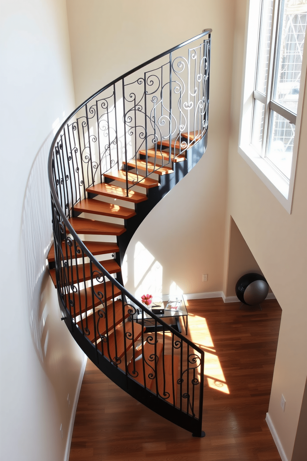 A stunning spiral staircase gracefully ascends, featuring a sleek metal railing with intricate artwork that adds an artistic touch to the space. The staircase is illuminated by natural light streaming through a large window, casting beautiful shadows on the polished wooden steps. The walls surrounding the staircase are adorned with soft, neutral tones that complement the bold metal design. A small, modern console table sits at the base, topped with decorative elements that enhance the overall aesthetic.