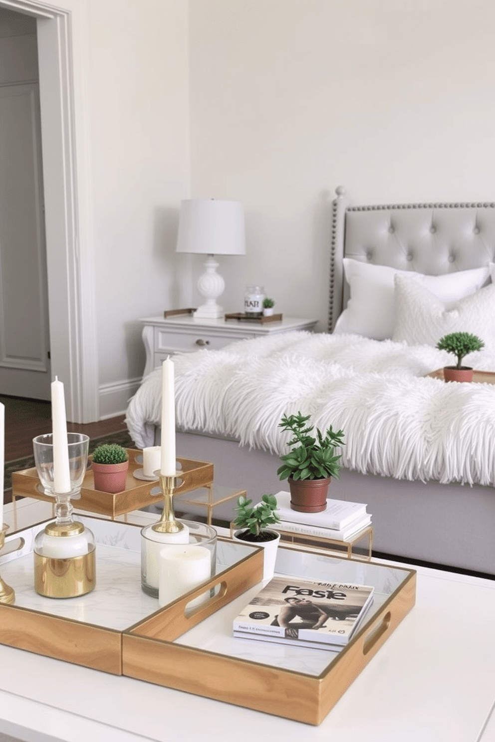 A bright and airy living room with soft pastel colors. Decorative trays in varying sizes are placed on the coffee table, holding candles and small potted plants for an organized yet inviting look. A cozy bedroom featuring a light gray upholstered bed with fluffy white bedding. Decorative trays on the nightstands showcase books and a small lamp, adding a touch of elegance and functionality to the space.