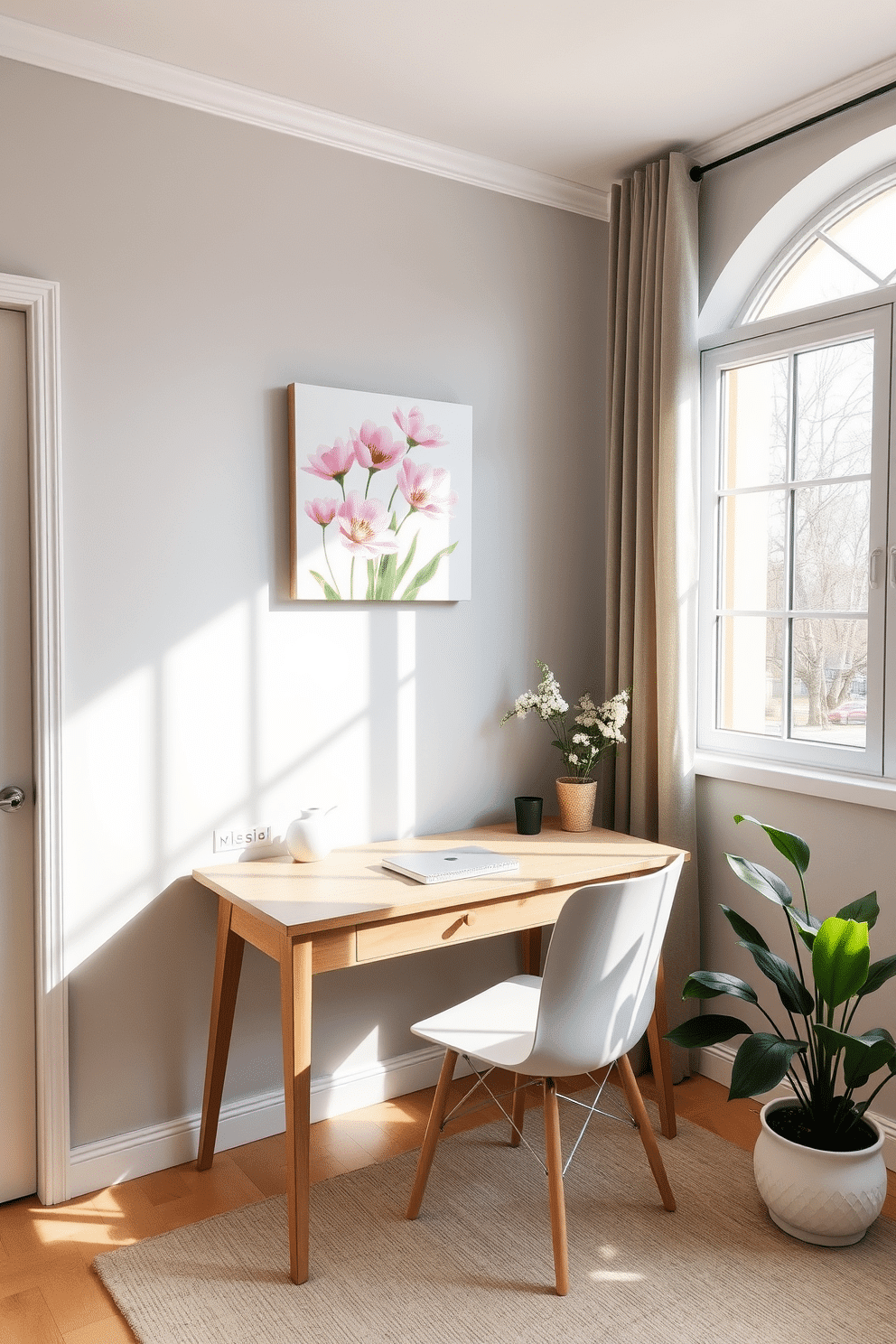 A serene home office space that embodies the essence of spring. The room features a light wooden desk positioned by a large window, allowing natural light to flood the area. On the wall above the desk, a nature-inspired artwork piece depicting blooming flowers adds a vibrant touch. The floor is adorned with a soft, neutral rug, and a potted plant sits in the corner, bringing life to the setting.