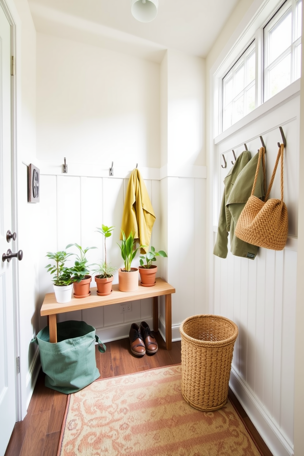 A bright and inviting mudroom features a series of potted plants arranged on a wooden bench. The walls are painted in a soft pastel color, and a large window allows natural light to flood the space. The floor is covered with a patterned rug that adds warmth and texture. Hooks are mounted on the wall for hanging jackets, and a stylish basket is placed nearby for storing shoes.