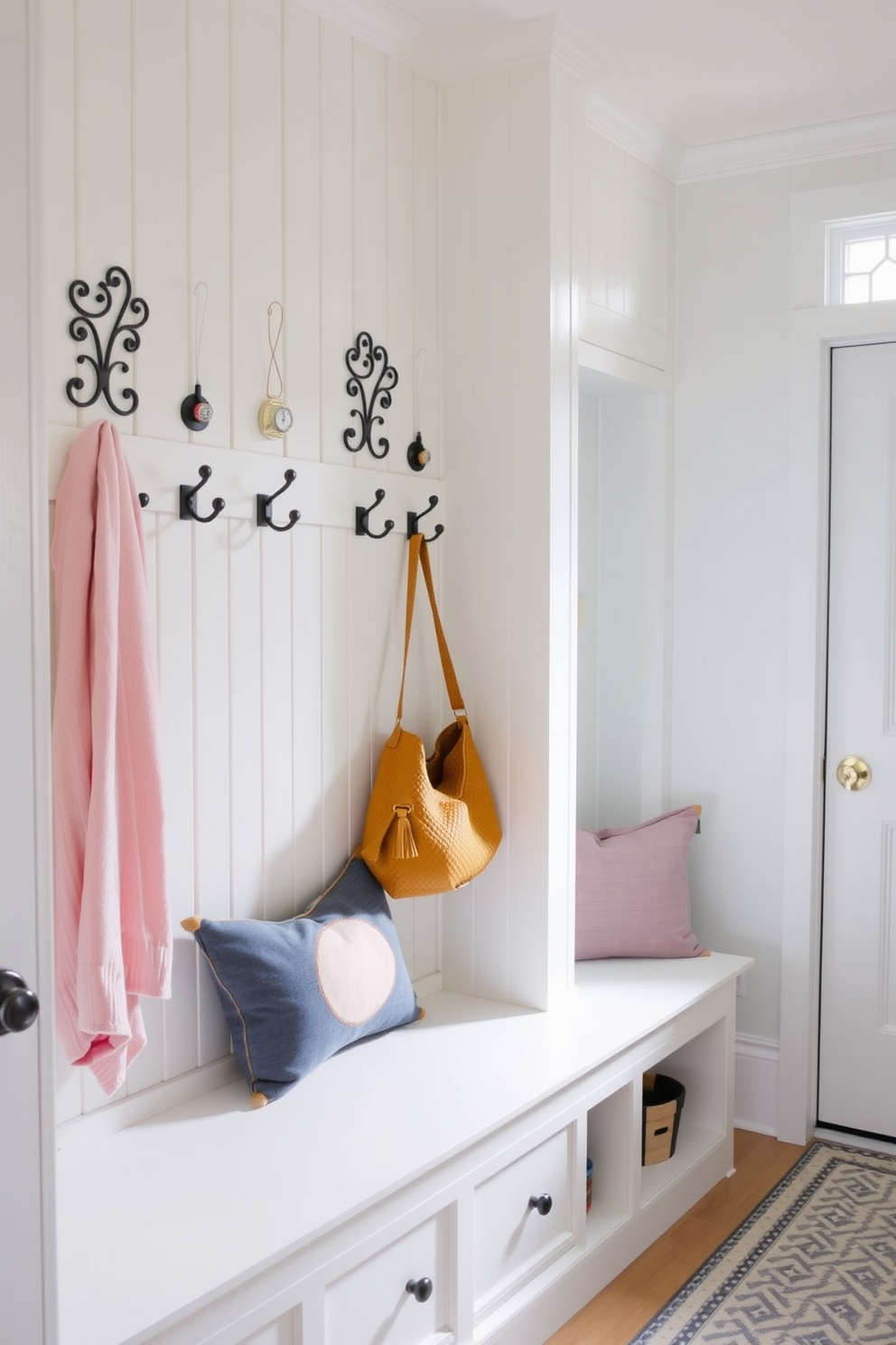 A bright and inviting mudroom features decorative hooks arranged on a light-colored wall, perfect for hanging coats and bags. The space is enhanced by a cheerful color palette of soft pastels, with a stylish bench for seating and storage underneath.