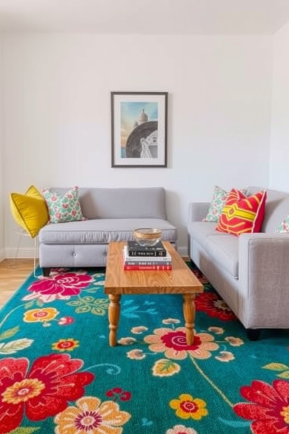 A vibrant area rug with floral patterns anchors the small living space, bringing warmth and personality to the room. The rug complements a cozy seating arrangement featuring a light gray sofa adorned with colorful throw pillows. A small wooden coffee table sits in the center, topped with a few stylish books and a decorative bowl. The walls are painted a soft white, allowing the bright colors of the rug and decor to stand out beautifully.