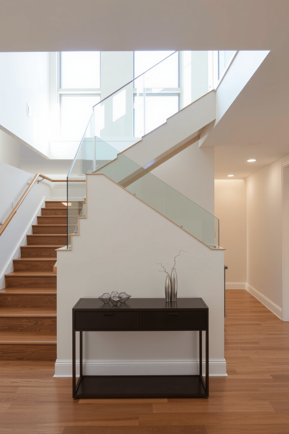 An open riser staircase elegantly ascends in a spacious foyer, allowing natural light to flood the area and create an airy ambiance. The treads are made of rich hardwood, while the risers are left open for a modern touch, complemented by a sleek glass railing that enhances the feeling of openness. The staircase features subtle LED lighting installed along the edges, highlighting the clean lines of the design. Below, a minimalist console table with decorative accents adds functionality without detracting from the staircase's visual appeal.