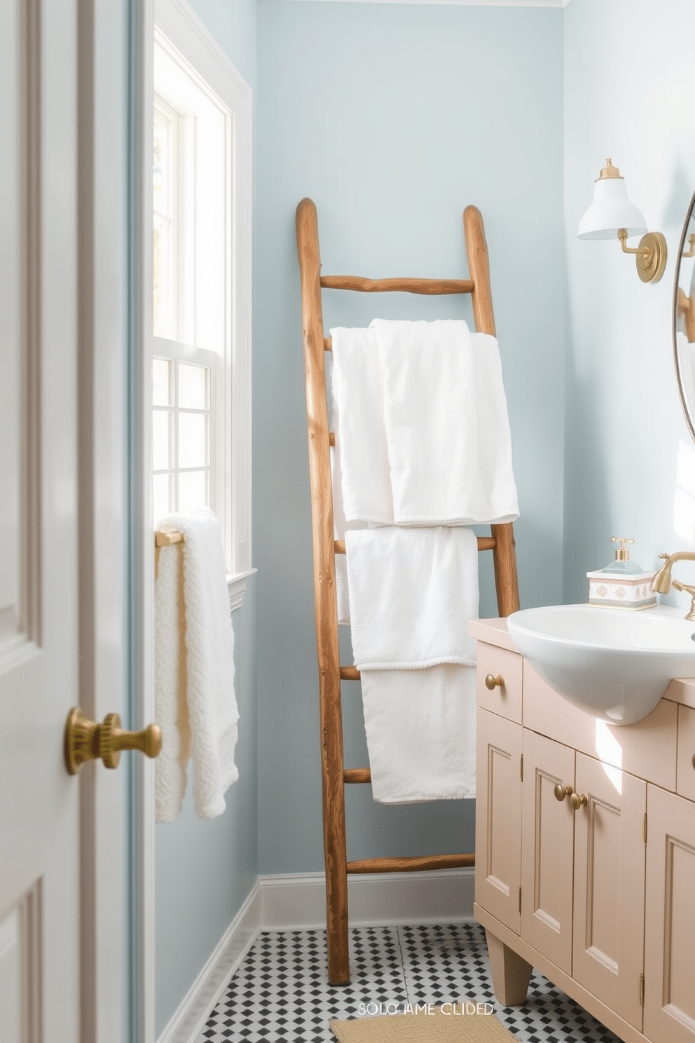 A bright and airy summer bathroom featuring a vintage wooden ladder leaning against the wall, adorned with plush white towels. The walls are painted in a soft pastel blue, complemented by a light wooden vanity with a white sink and brass fixtures.