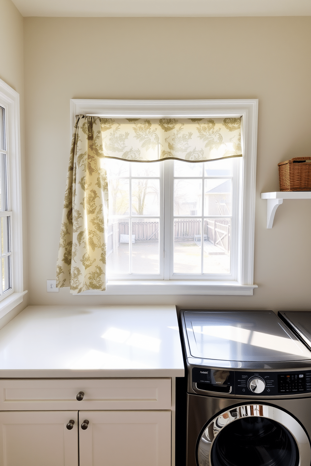 A bright and airy laundry room with large windows allowing natural light to flood the space. The walls are painted in a soft pastel color, and a decorative curtain in a floral pattern hangs elegantly by the window for added privacy. A spacious countertop made of white quartz provides ample space for folding clothes, complemented by open shelving above displaying neatly arranged baskets. A stylish washing machine and dryer set in a sleek finish are positioned side by side, enhancing the room's functionality and aesthetic appeal.