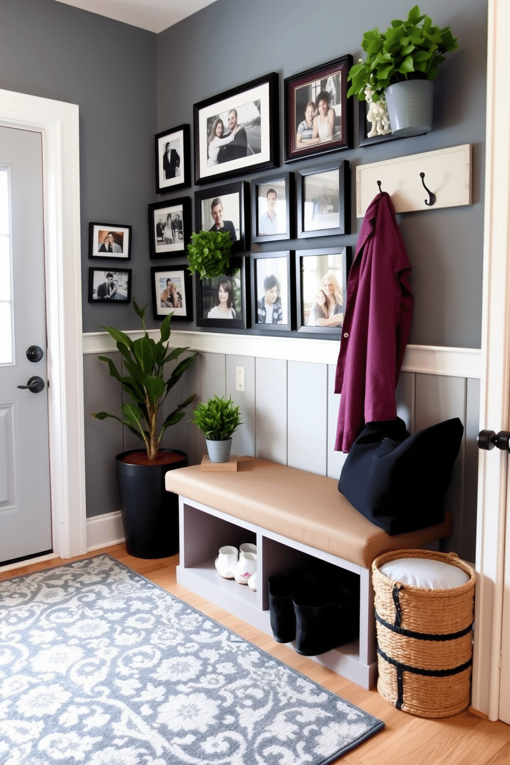 A welcoming mudroom features a functional bench with built-in storage underneath. The walls are adorned with a gallery wall showcasing framed family photos in various sizes and styles, creating a personal touch. The floor is covered with a durable, patterned rug that complements the color scheme. A stylish coat rack hangs on the wall, and potted plants add a touch of greenery to the space.