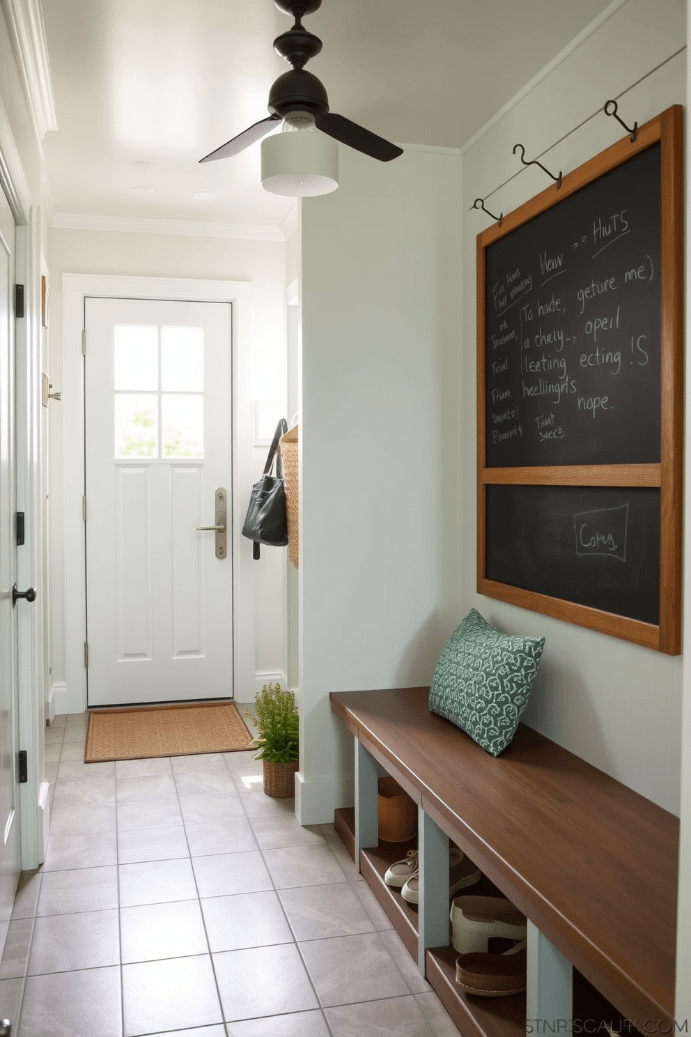 A functional summer mudroom features a spacious layout with ample storage solutions. The walls are painted in a light airy color, complemented by a durable tile floor that can withstand outdoor elements. A large chalkboard is mounted on one wall, perfect for leaving messages and notes. Stylish hooks are installed for hanging bags and jackets, while a cozy bench provides a place to sit and remove shoes.