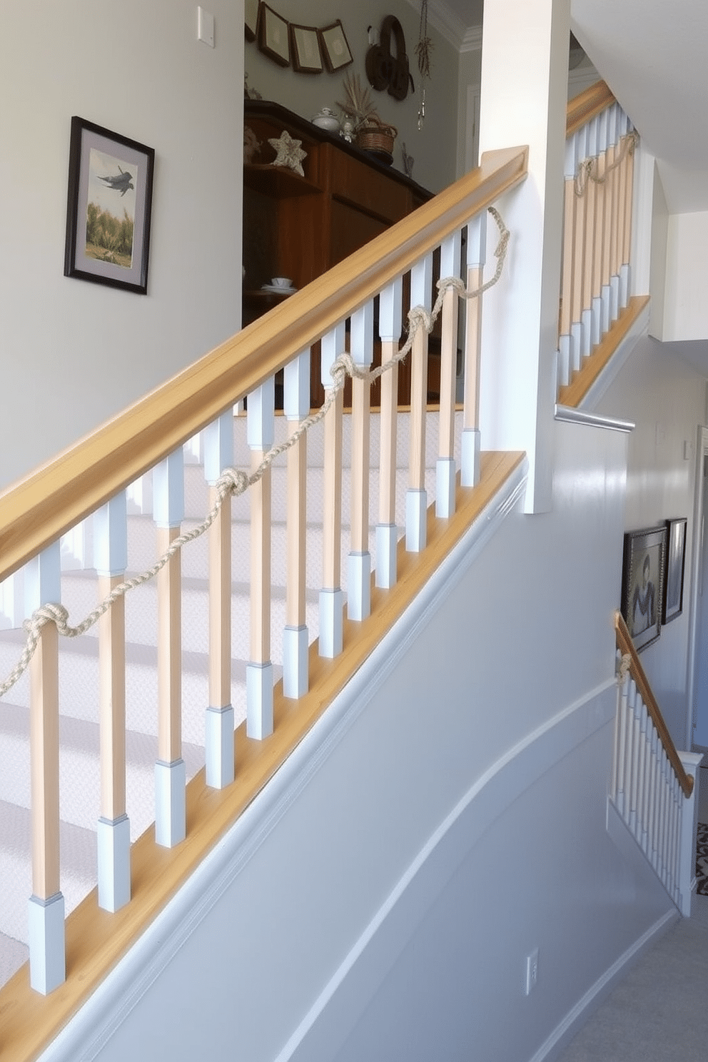 A coastal-inspired stair railing with natural wood finishes and nautical elements creates an inviting atmosphere. The railing features rope accents and subtle blue hues that complement the airy feel of the space. The staircase is adorned with light-colored runners that evoke a beachy vibe, enhancing the overall coastal theme. Decorative elements like seashells and driftwood accents are strategically placed along the steps for added charm.