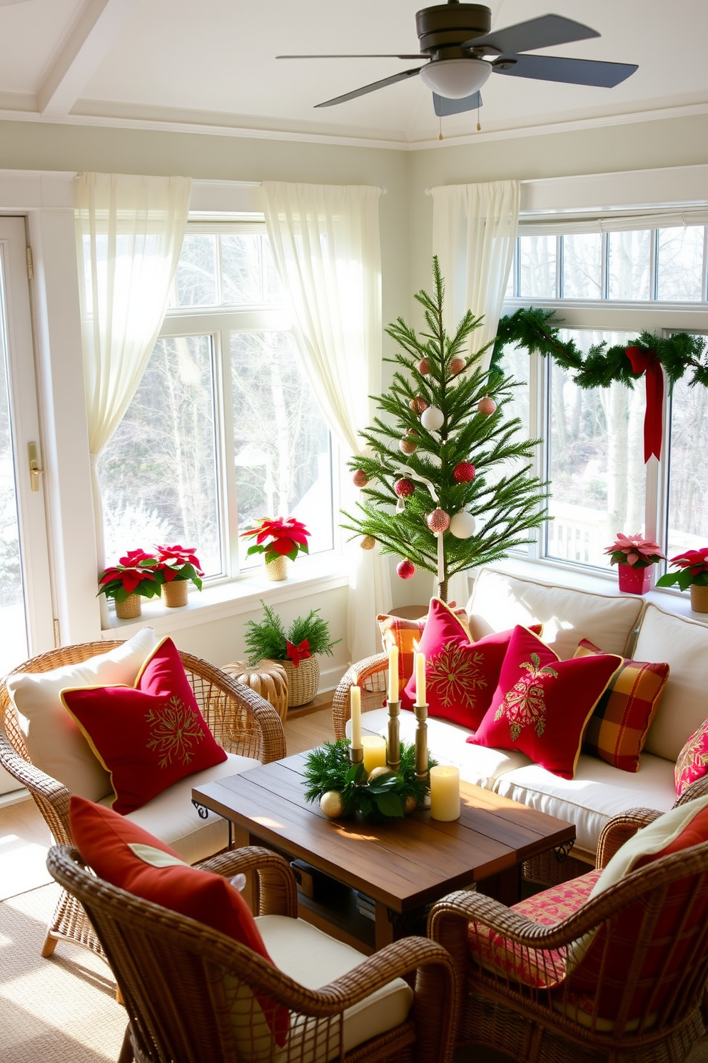 A sunroom filled with natural light, featuring a cozy seating area adorned with colorful Christmas pillows in vibrant reds, greens, and golds. The furniture includes a plush white sofa and a pair of wicker chairs, all arranged around a rustic wooden coffee table topped with festive ornaments and candles. The windows are draped with sheer white curtains, allowing the soft winter sunlight to filter in, while a small evergreen tree stands in the corner, decorated with twinkling lights and ornaments. Potted poinsettias and garlands of greenery are placed along the window sills, enhancing the cheerful holiday atmosphere.