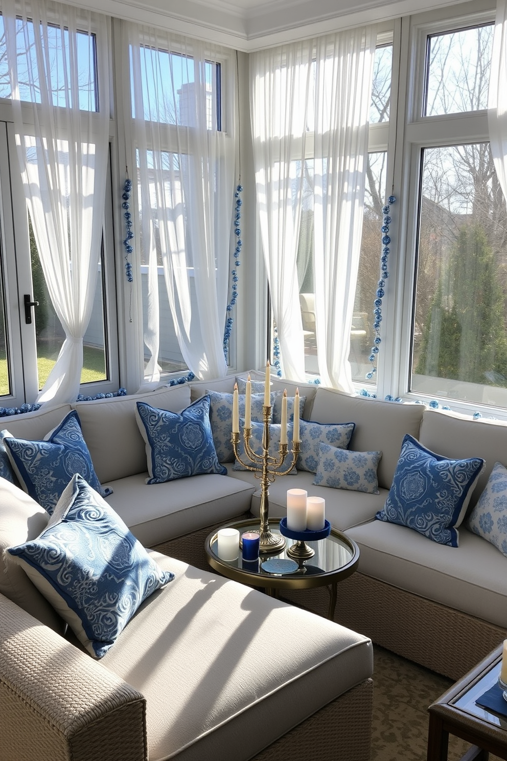 A serene sunroom decorated for Hanukkah, featuring plush blue and white themed cushions arranged on a large, cozy sectional sofa. The cushions showcase intricate patterns and textures, complementing the natural light streaming through expansive windows adorned with sheer white curtains. Festive decorations include a beautifully lit menorah positioned on a coffee table, surrounded by blue and white candles. Delicate garlands of blue and silver ornaments drape gracefully along the window sills, enhancing the joyful atmosphere of the space.