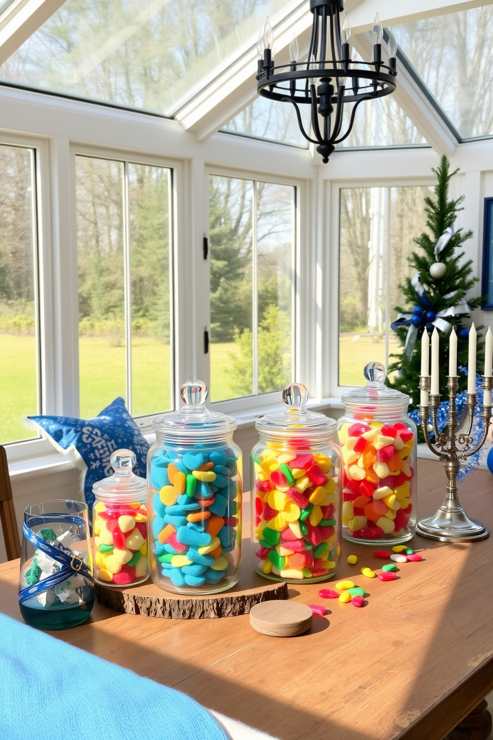 A cozy sunroom filled with natural light, featuring a collection of elegant glass jars filled with colorful gelt. The jars are arranged on a rustic wooden table, surrounded by festive Hanukkah decorations such as blue and silver accents and a menorah, creating a warm and inviting atmosphere.