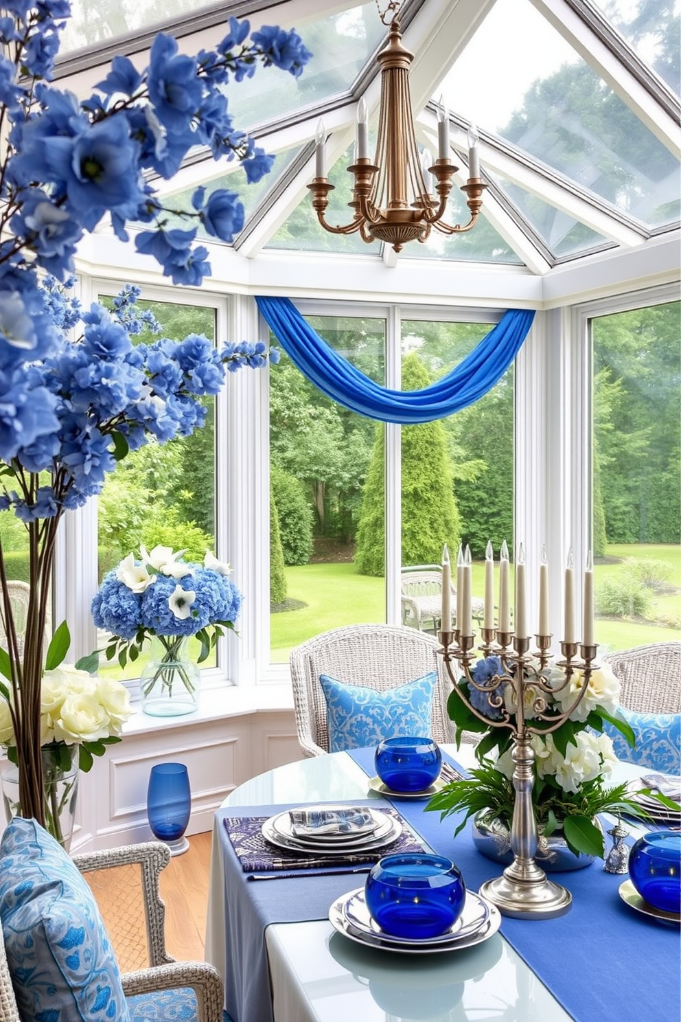 A sunroom adorned with blue and white flower arrangements. The space is filled with natural light, featuring large windows that overlook a lush garden, creating a tranquil atmosphere. For Hanukkah decorating ideas, the sunroom is decorated with elegant blue and silver accents. A beautifully arranged table showcases menorahs and festive centerpieces, enhancing the warmth and spirit of the holiday.